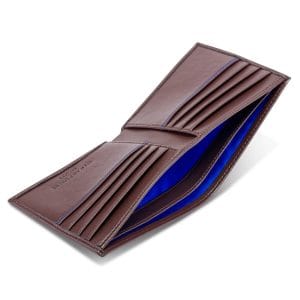 Brown bifold wallet with cobalt blue lining, revealing multiple card slots and compartments. Made from vegan corn leather with RFID security.