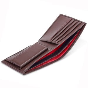 Chestnut brown coin wallet with a vibrant red interior, structured for secure cash and card storage with an expandable coin section.